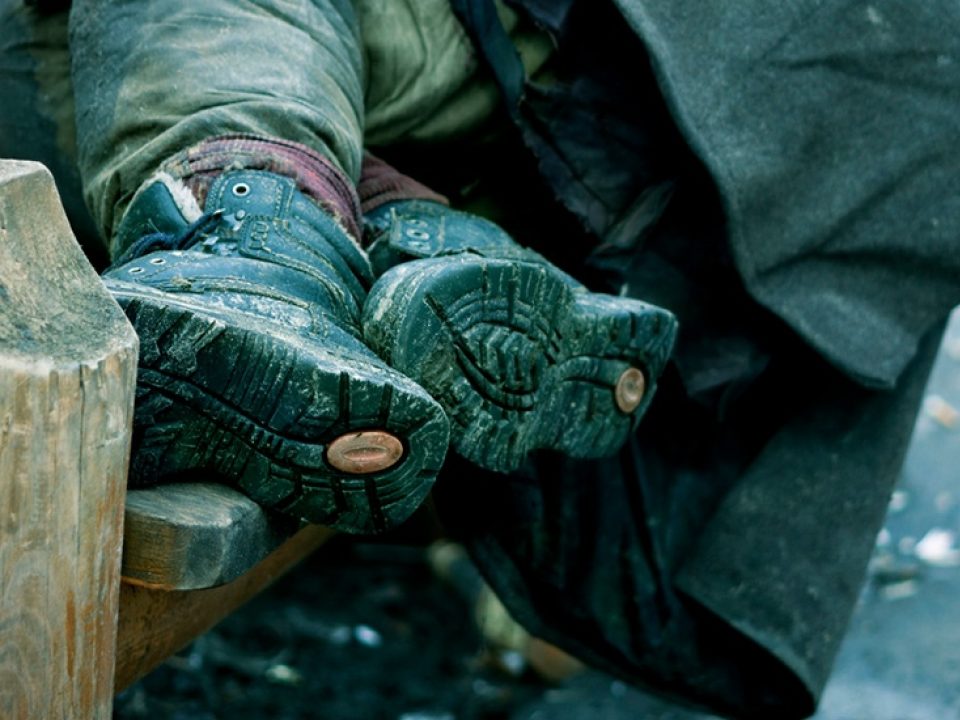 Rough-sleeper-with-feet-on-bench-stock-image-1.jpg