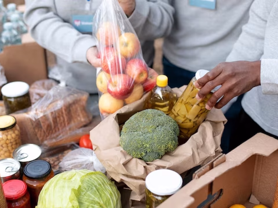 close-up-volunteers-collecting-food-donations_23-2149182031.avif